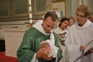 The newly ordained Rev. Javen Swanson presiding at his first baptism.