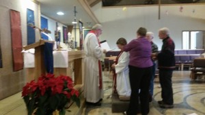 Mary Knutson and family placing of the ordination stole around Cara Knutson’s shoulders.