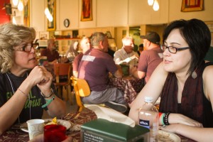 Rev. Brenda Bos (left) visits with seminarian Fred Demien (right). Photo by Emily Ann Garcia.